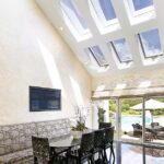 The combination in the interior of panoramic windows and skylights