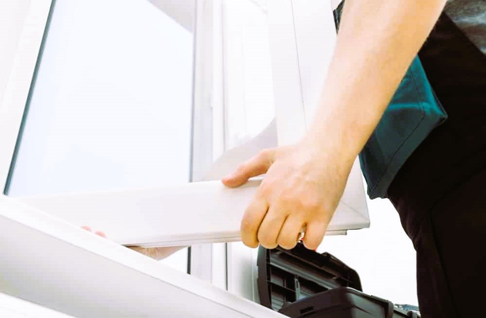 Professional handyman installing window